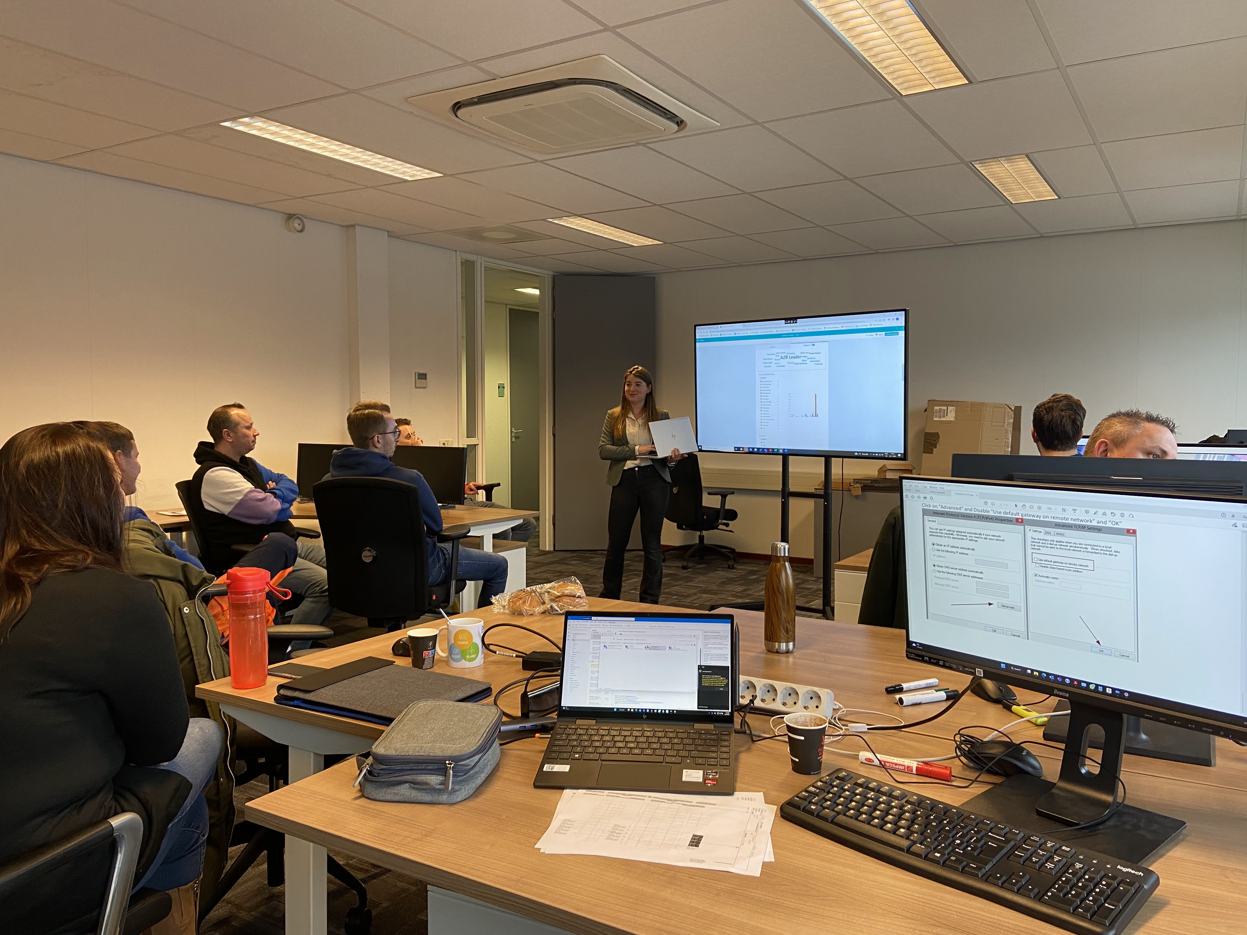 Training room presentation with people watching screen